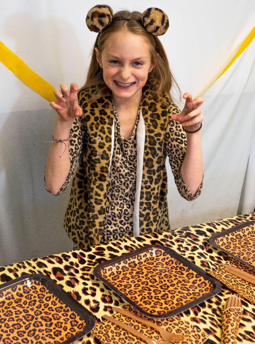 Leopard print party tableware set including plates, napkins, forks, and spoons, perfect for adding a touch of wild to any celebration.