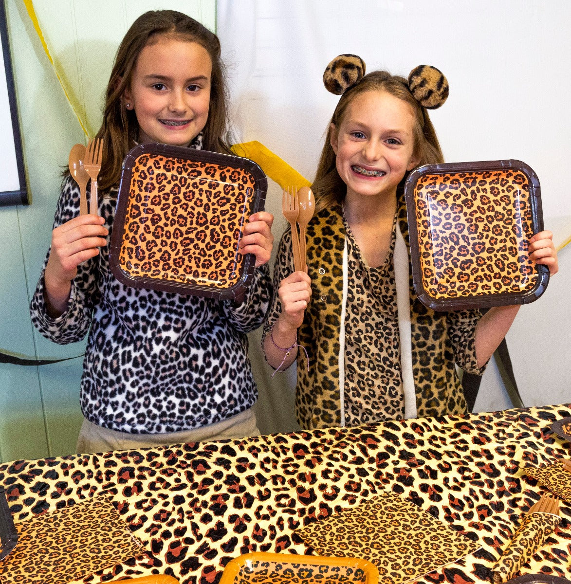 Leopard print party tableware set including plates, napkins, forks, and spoons, perfect for adding a touch of wild to any celebration.