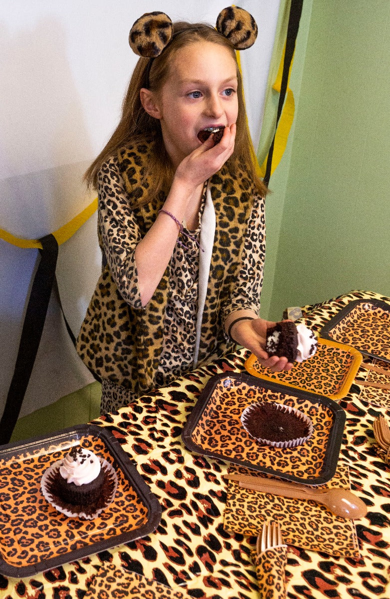 Leopard print party tableware set including plates, napkins, forks, and spoons, perfect for adding a touch of wild to any celebration.