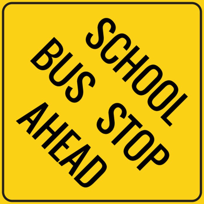  front view of a school bus with the door open and the stop sign out