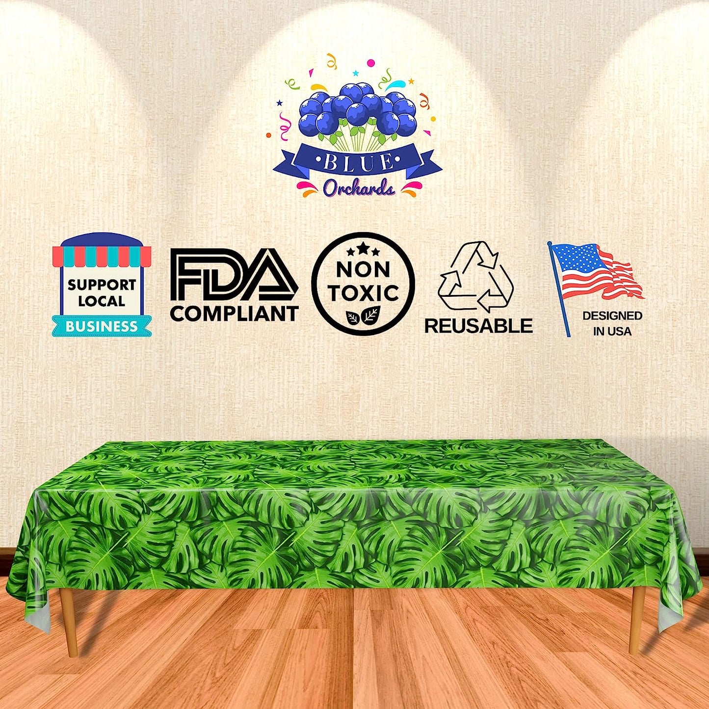 Two FDA Compliant, non toxic, reusable, and designed in USA palm leaf patterned table covers, each measuring approximately 108 inches by 54 inches, displayed on a wooden table with a white background.